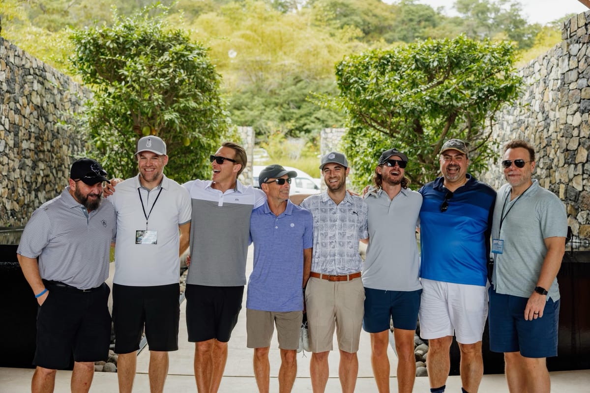 Chris Carey with a group of friends, arms around each other